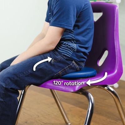Image of boy sitting on blue rotatable disc cushion on purple chair.
