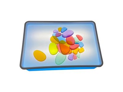 Lightbox with translucent pebbles on tray.