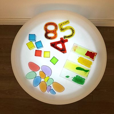Colour changing table with different translucent objects on the surface
