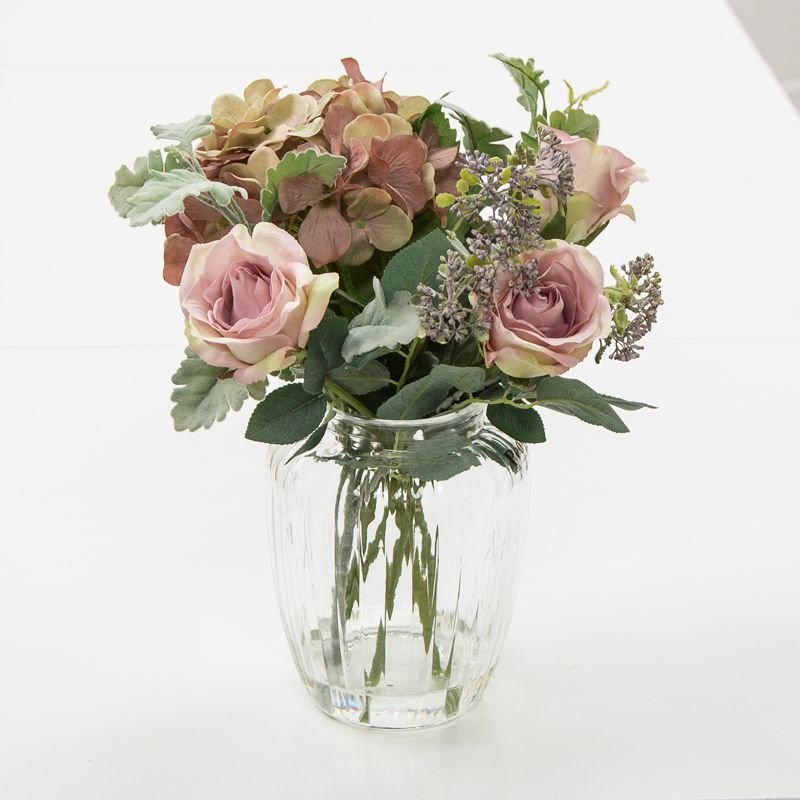 Artificial vintage mauve hydrangeas, roses, pale green foliage and summer blue patrina pick in an Optic Vase Artificial vintage mauve hydrangeas, roses, pale green foliage and summer blue patrina pick in an Optic Vase
