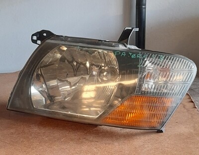 Farol Mitsubishi Pajero 2003