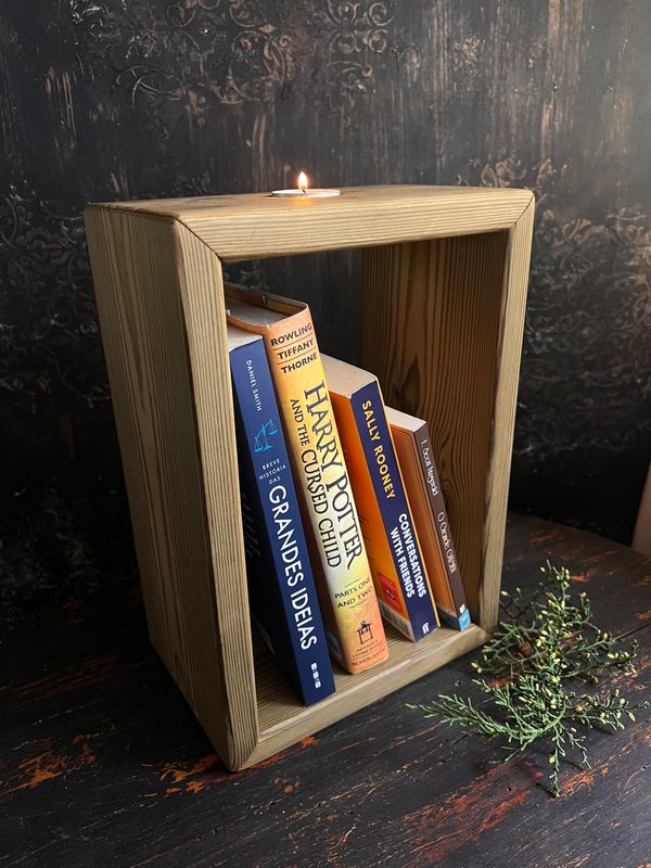 Wooden decorative shelf with a small candle