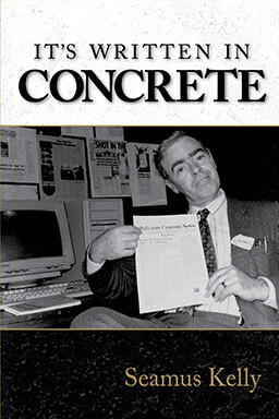 It's Written in Concrete by Seamus Kelly Front cover of It's Written in Concrete by Seamus Kelly featuring a photograph of the author, holding up a copy of the inaugural issue of Ballymun Concrete News.