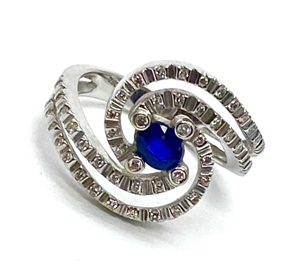 Blue Sapphire and Diamond Swirl Ring in White Gold