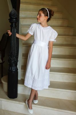 White cotton batiste flower girl dress with puff sleeves and full gathered skirt, perfect for weddings or baptisms