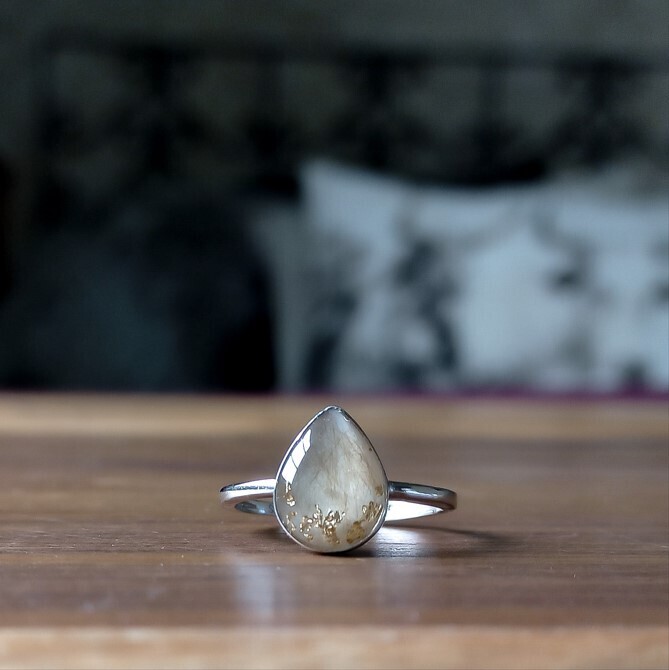 Drop ring with baby hair and gold leaf pieces