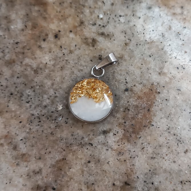 Circular pendant with breast milk and gold leaf pieces