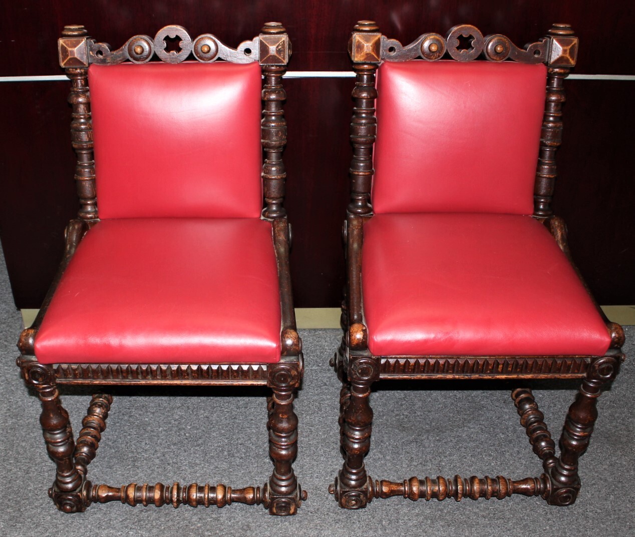 Pair of Renaissance Revival Carved Oak Red Leather Upholstered Chairs on Casters