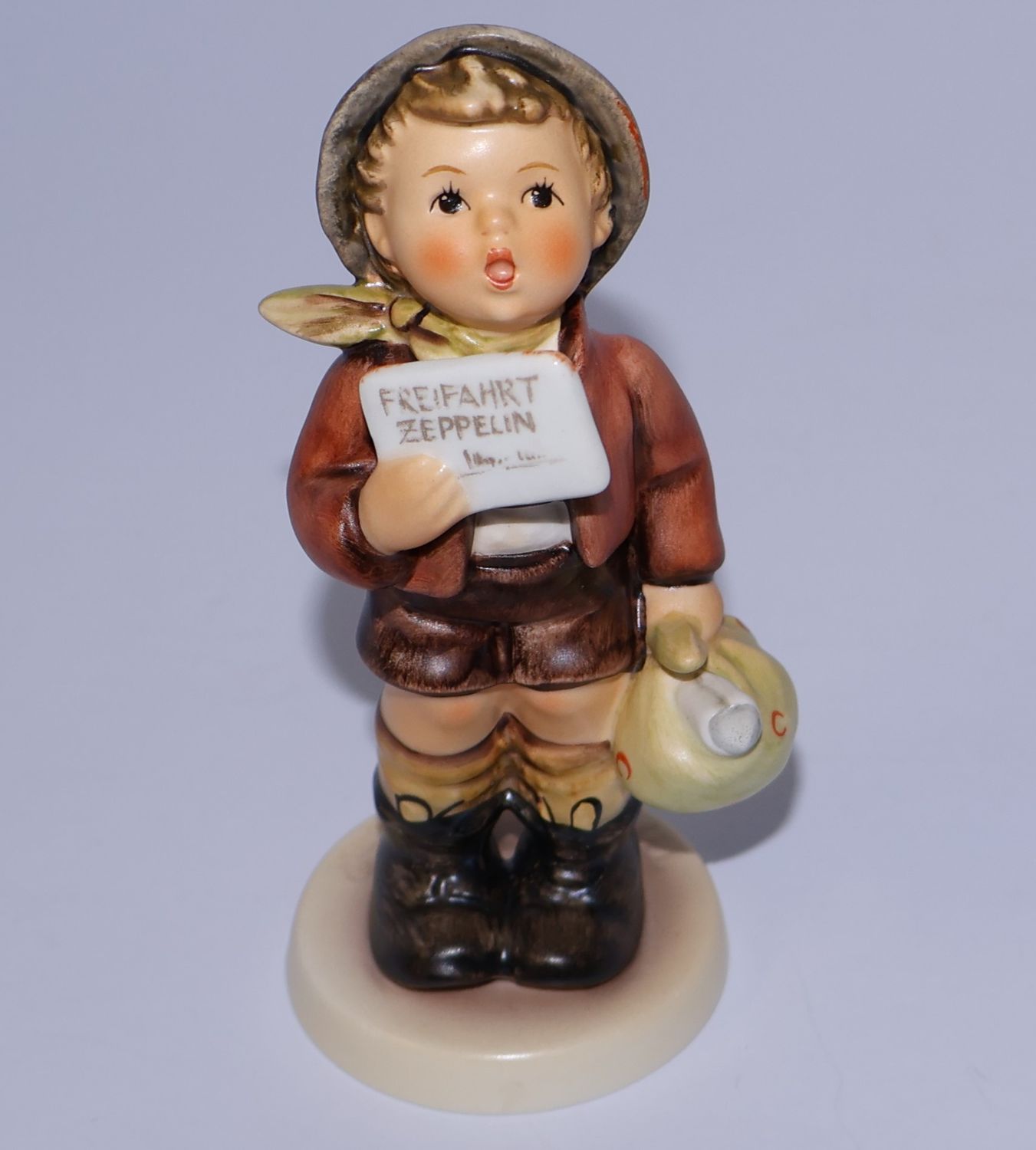 Hummel “A Free Flight” Boy holding Ticket Figurine - TMK-7 | #569 | First Issue 1993