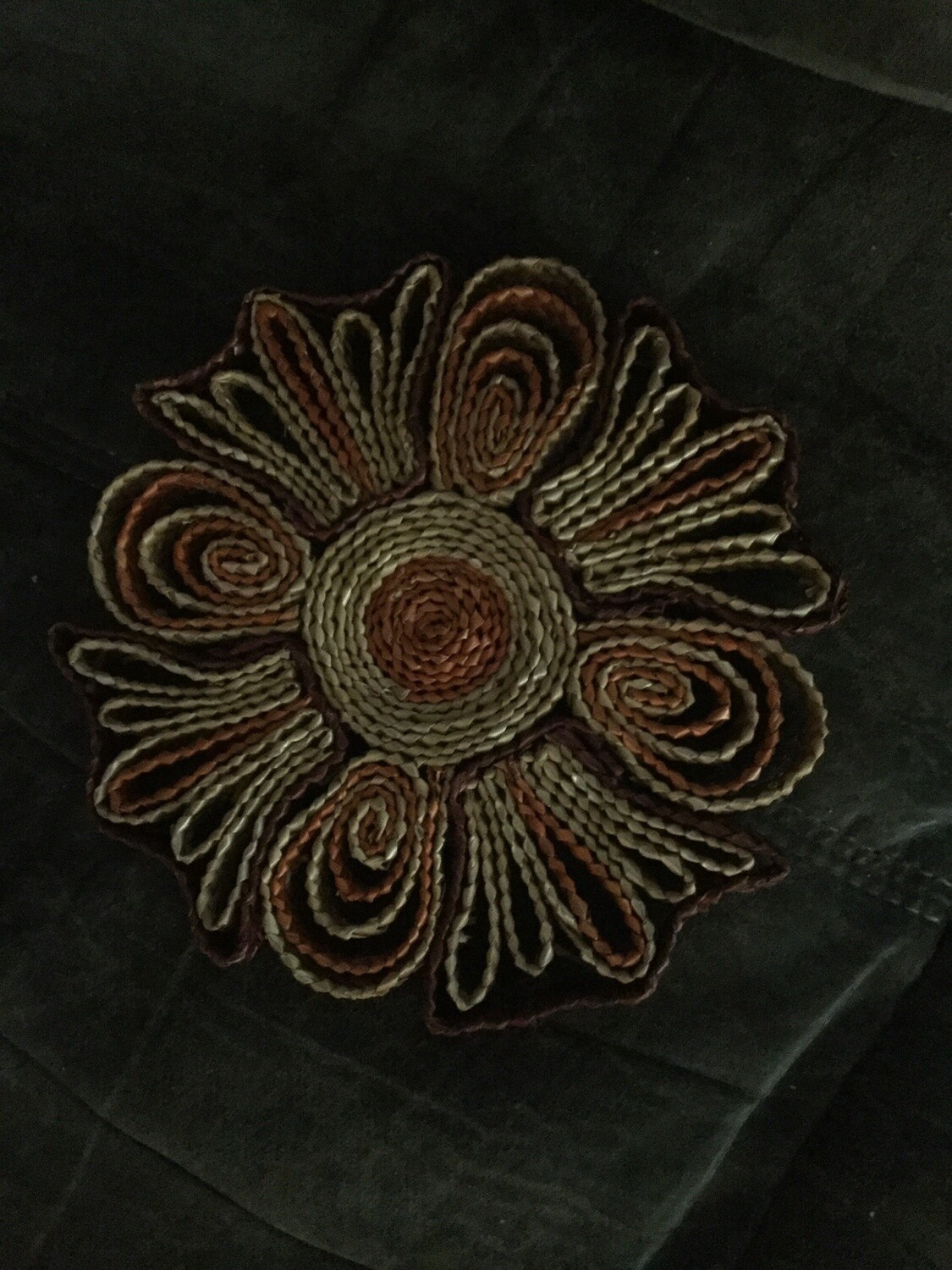 Wicker trivet enchanted to sanctify atmosphere, anoint room for spiritual purposes