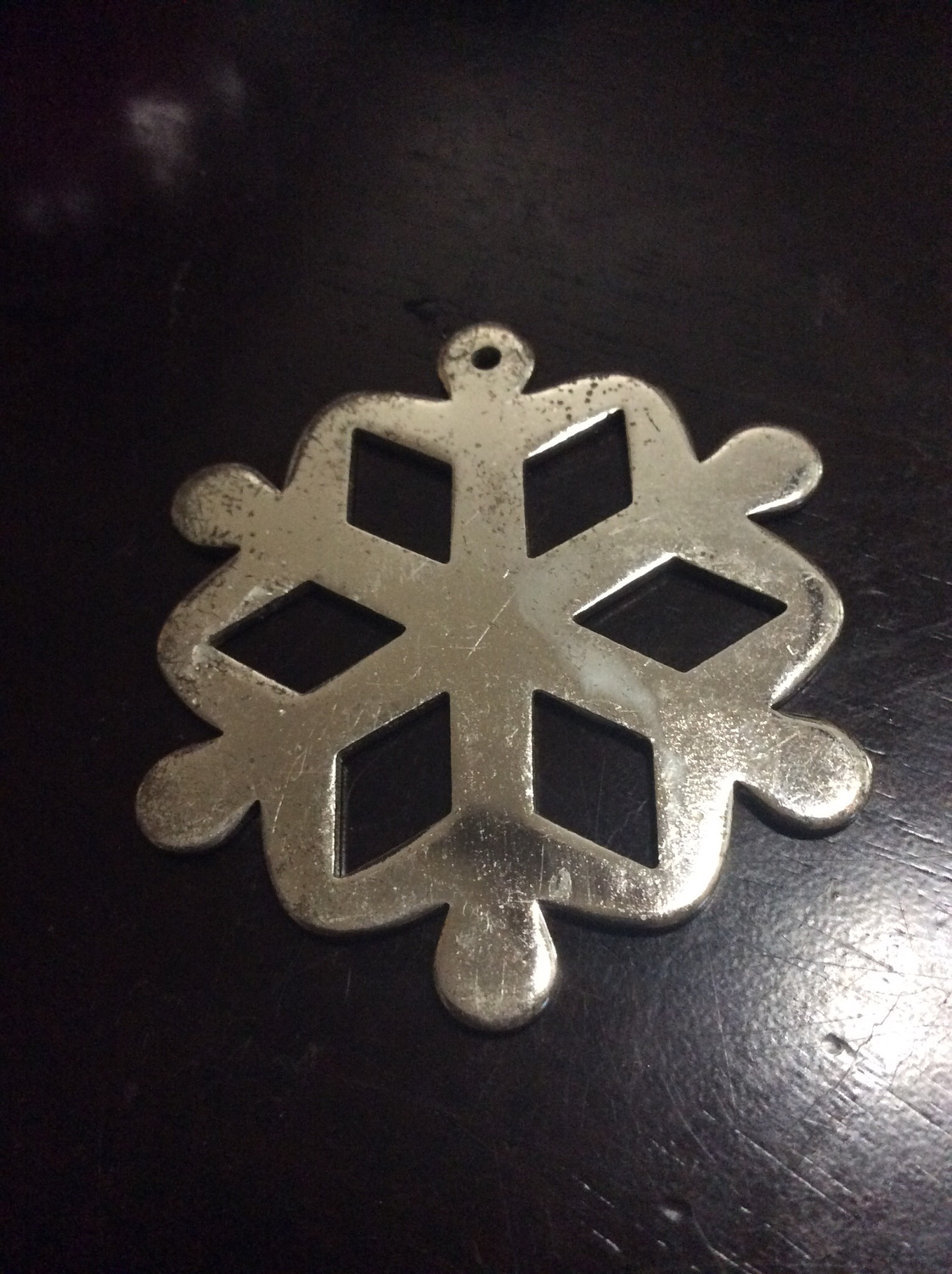 Metal snowflake ornament bring people together in harmony peace and joy 