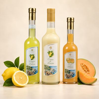 Amalfi limoncello, lemon cream and melon cream liqueur bottles with fresh lemon and melon