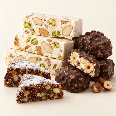 Italian Christmas sweets: almond and pistachio torrone, chocolate-coated nougat and fruit-and-nut panforte