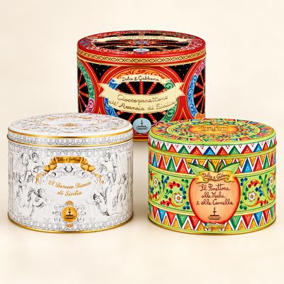 Dolce and Gabbana panettone tins: white and gold Barocco, red Sicilian orange, and colourful apple and cinnamon