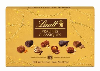 Lindt Pralines Classiques 407g gold gift box of assorted milk, dark and white chocolates on a white background