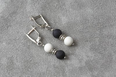 Короткие серьги, украшенные маленькими шариками из белого и черного фарфора.  Short earrings decorated with small balls of white and black porcelain.