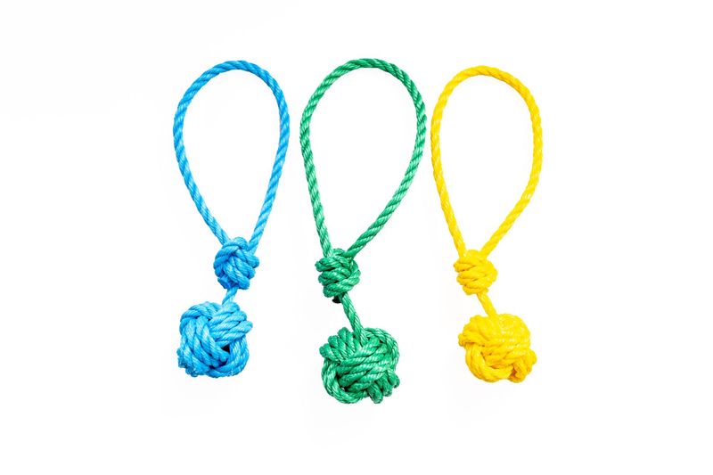 Three rope dog toys. Each one has a large monkeypaw knot on one end, and loops around with a slipknot on the other end, creating a loop handle that can get longer or shorter.  They come in blue, yellow, or green.