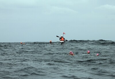 Swimming with a kayaker Swimming with a kayaker