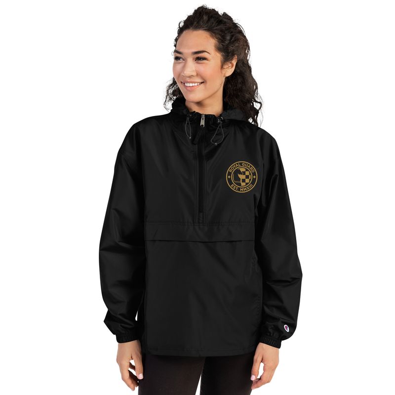 woman wearing black pullover jacket with gold Royal Guard seal embroidered at the left chest