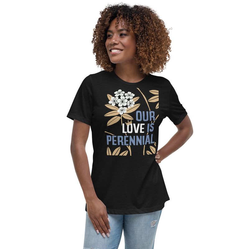 woman wearing black T-shirt, showing light blue and white lettering &quot;OUR LOVE IS PERENNIAL&quot; and rhododendrons with white blossoms and gold leaves