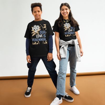 two children wearing black T-shirts with design of light blue and white lettering &quot;OUR LOVE IS PERENNIAL&quot; and rhododendrons with white blossoms and gold leaves