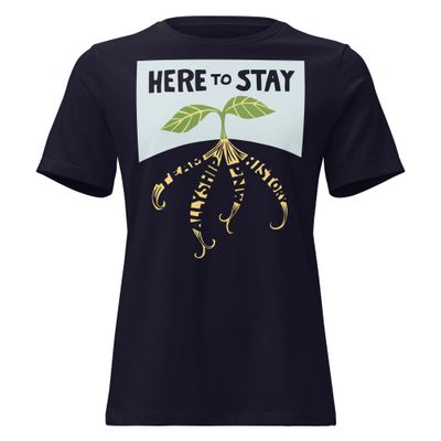 front of navy T-shirt with lettering "HERE TO STAY" over sprout with roots "TEAM," "ALLYSHIP," "PNW," and "HISTORY"