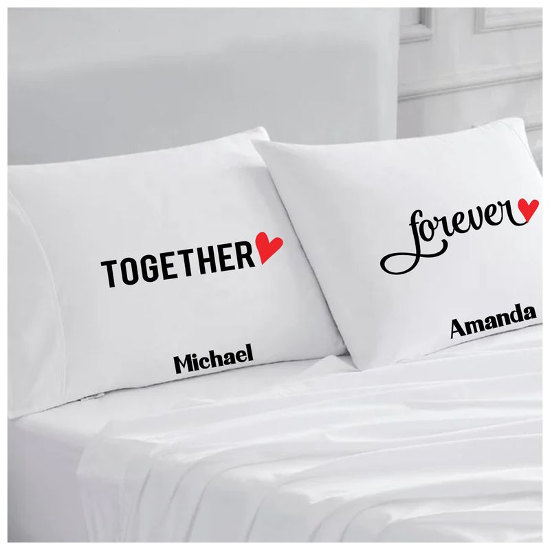 Personalized couples pillowcases with two names printed in a warm, romantic design on soft white fabric.