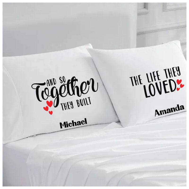 Personalized couples pillowcases with two names printed in a warm, romantic design on soft white fabric.