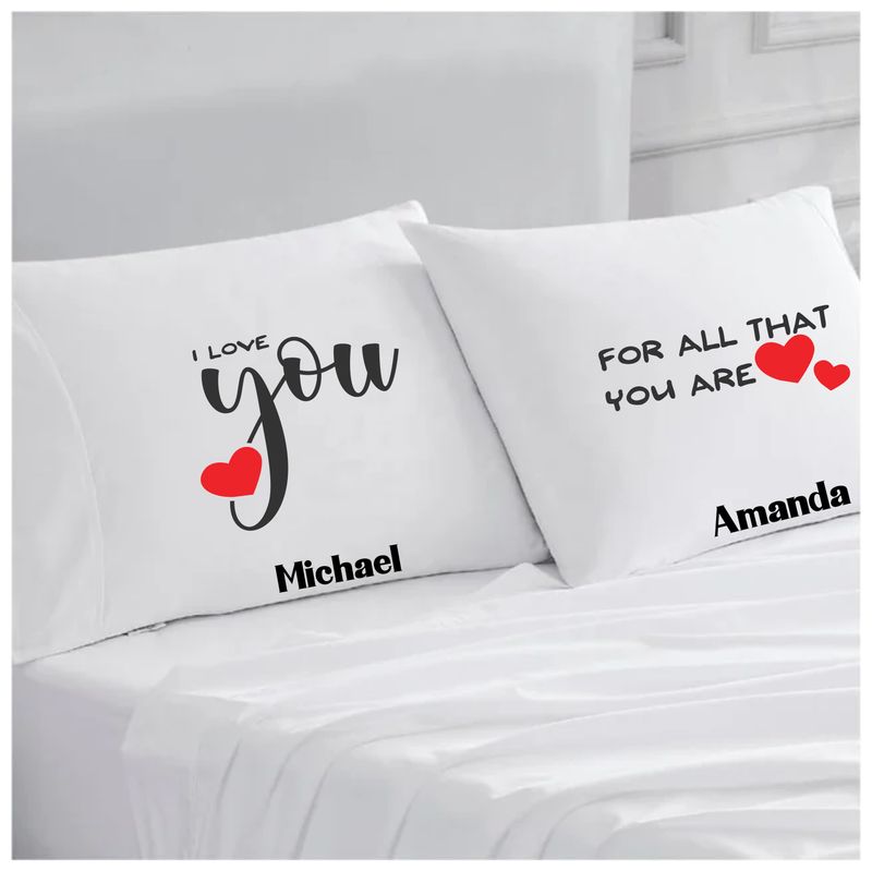 Personalized couples pillowcases with two names printed in a warm, romantic design on soft white fabric.