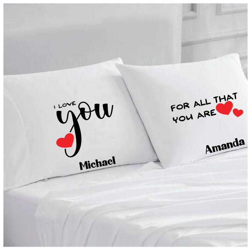 Personalized couples pillowcases with two names printed in a warm, romantic design on soft white fabric.