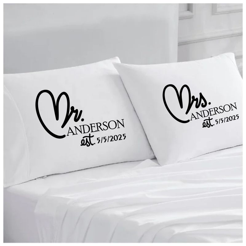 Personalized couples pillowcases with two names printed in a warm, romantic design on soft white fabric.