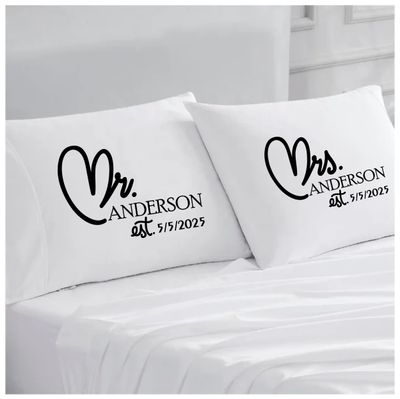 Personalized Couples Pillowcases with Sweet Words | His and Hers Gifts Personalized couples pillowcases with two names printed in a warm, romantic design on soft white fabric.