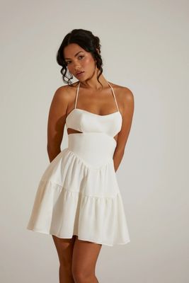 Women's Premium Quality white halter neck mini dress with cut-out details and a ruffled skirt.- 100 Pc