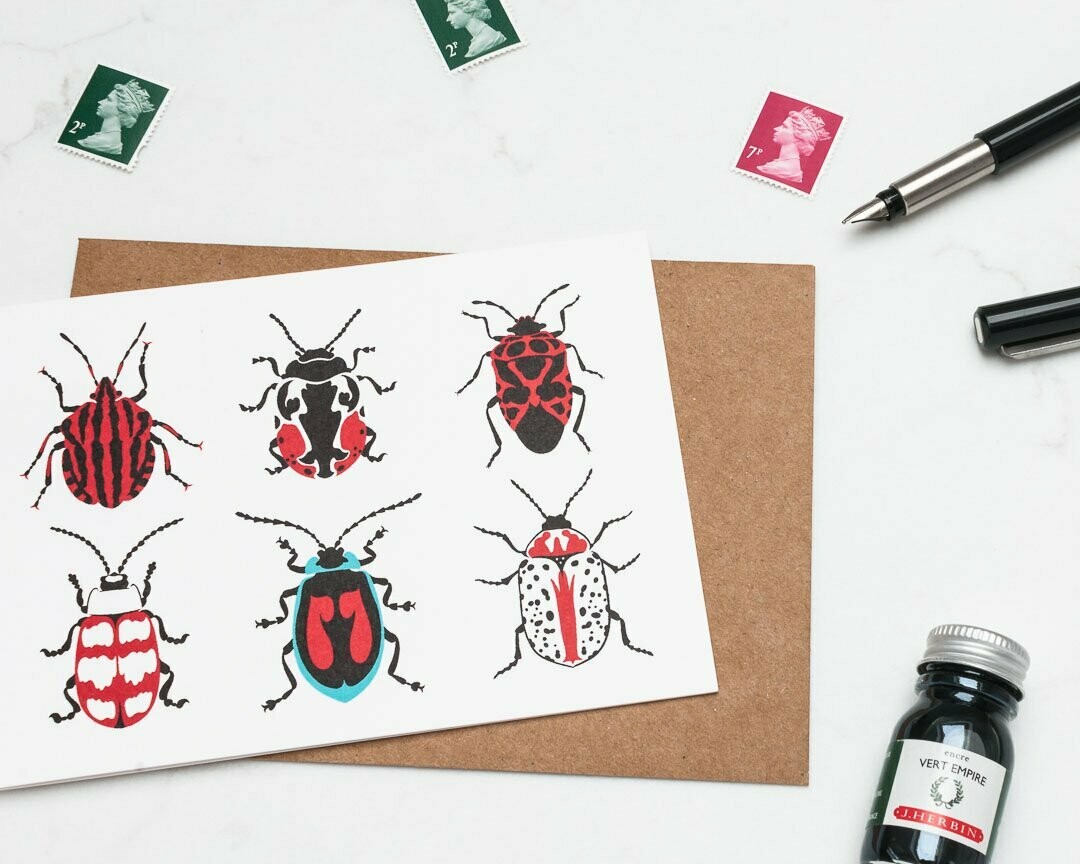Red beetles greeting card