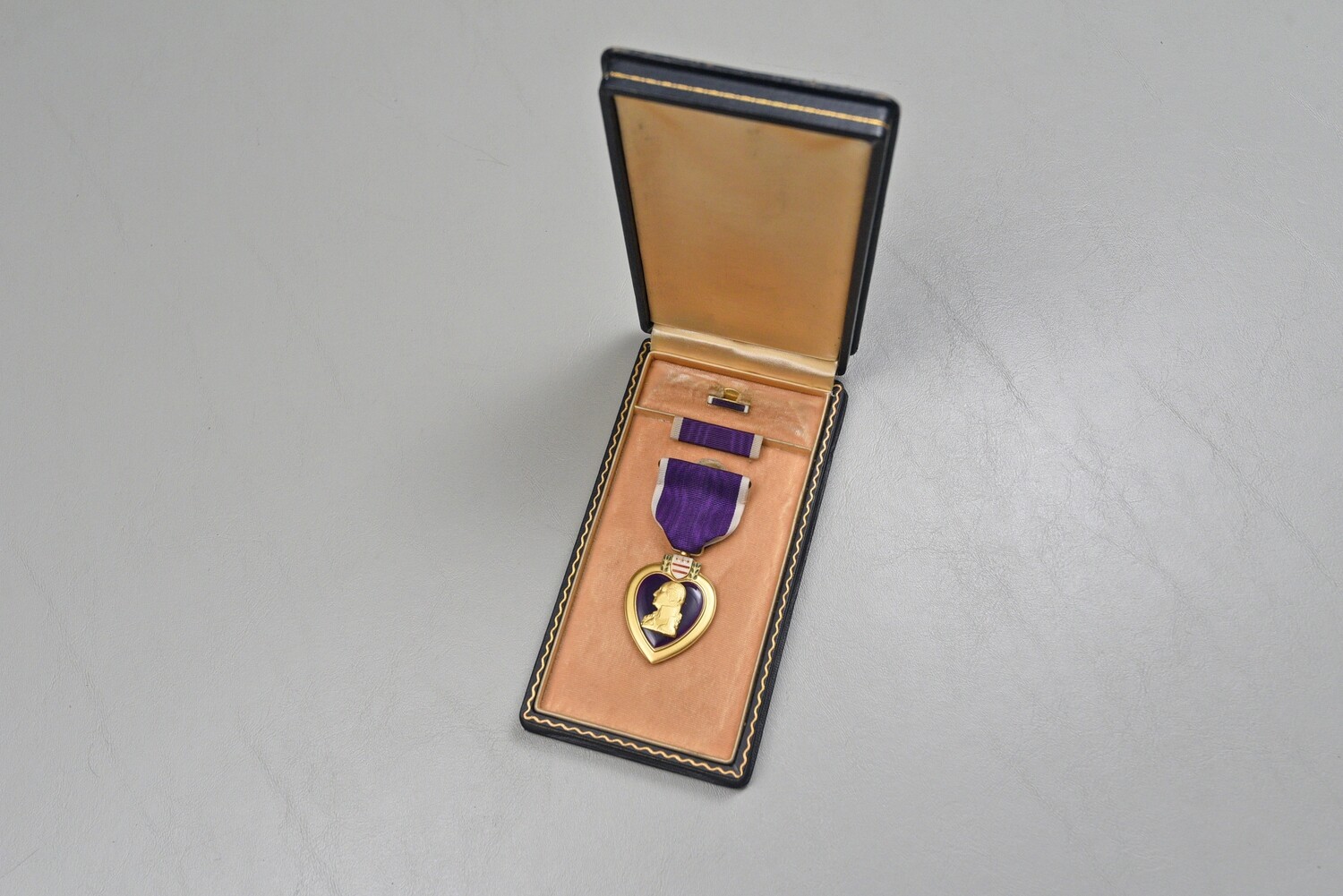 WWII U.S. PURPLE HEART MEDAL SET IN BLACK LEATHERETTE CASE