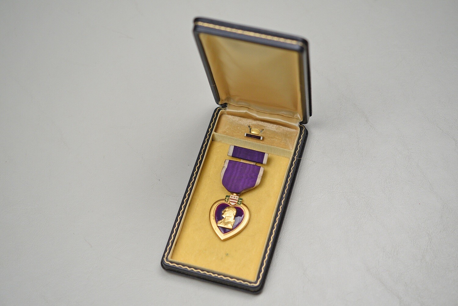 WWII U.S. PURPLE HEART MEDAL SET IN BLACK LEATHERETTE CASE