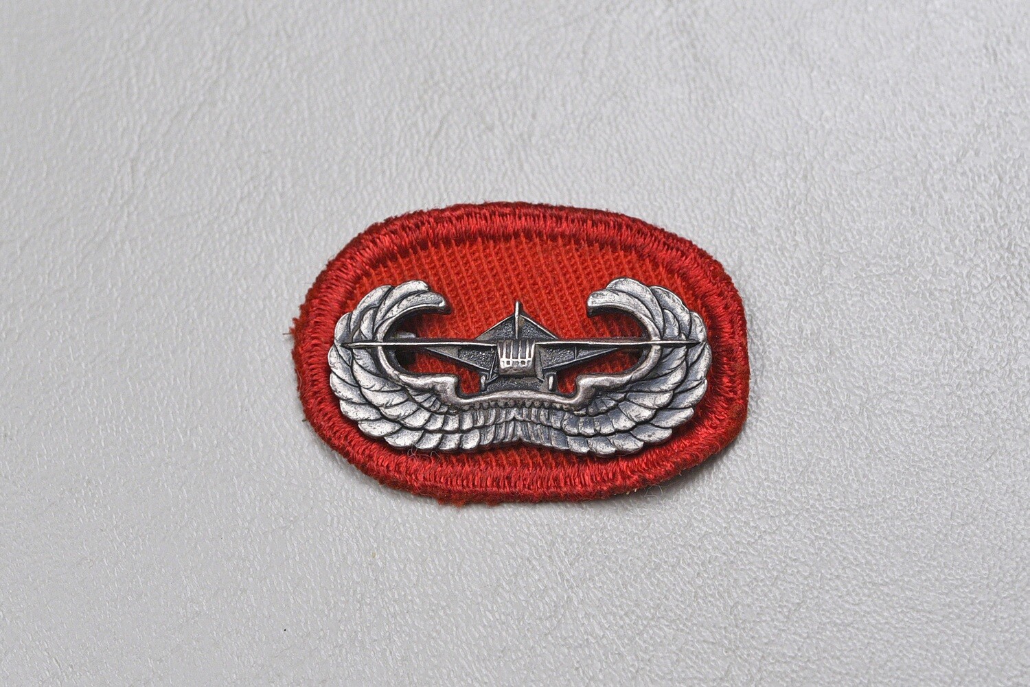 WWII U.S. GLIDER ASSAULT BADGE ON ARTILLERY/ENGINEER OVAL - PINBACK, STERLING