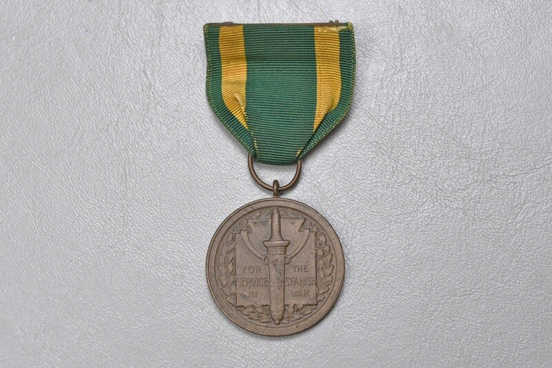 U.S. SPANISH AMERICAN WAR SERVICE MEDAL - WRAP BROACH, NUMBERED RIM