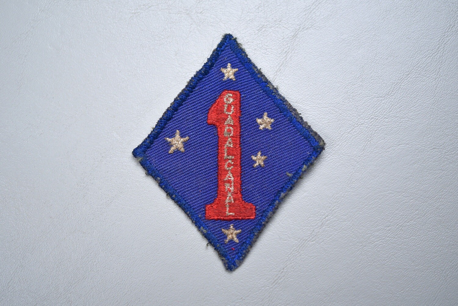 WWII U.S. 1st MARINE DIVISION SHOULDER PATCH ON TWILL - UNIFORM REMOVED