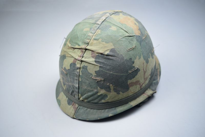 VIETNAM WAR U.S. M1C PARATROOPER STEEL COMBAT HELMET w/MITCHELL CAMO COVER – DATED ‘64’ VIETNAM WAR U.S. M1C PARATROOPER STEEL COMBAT HELMET w/MITCHELL CAMO COVER – DATED ‘64’