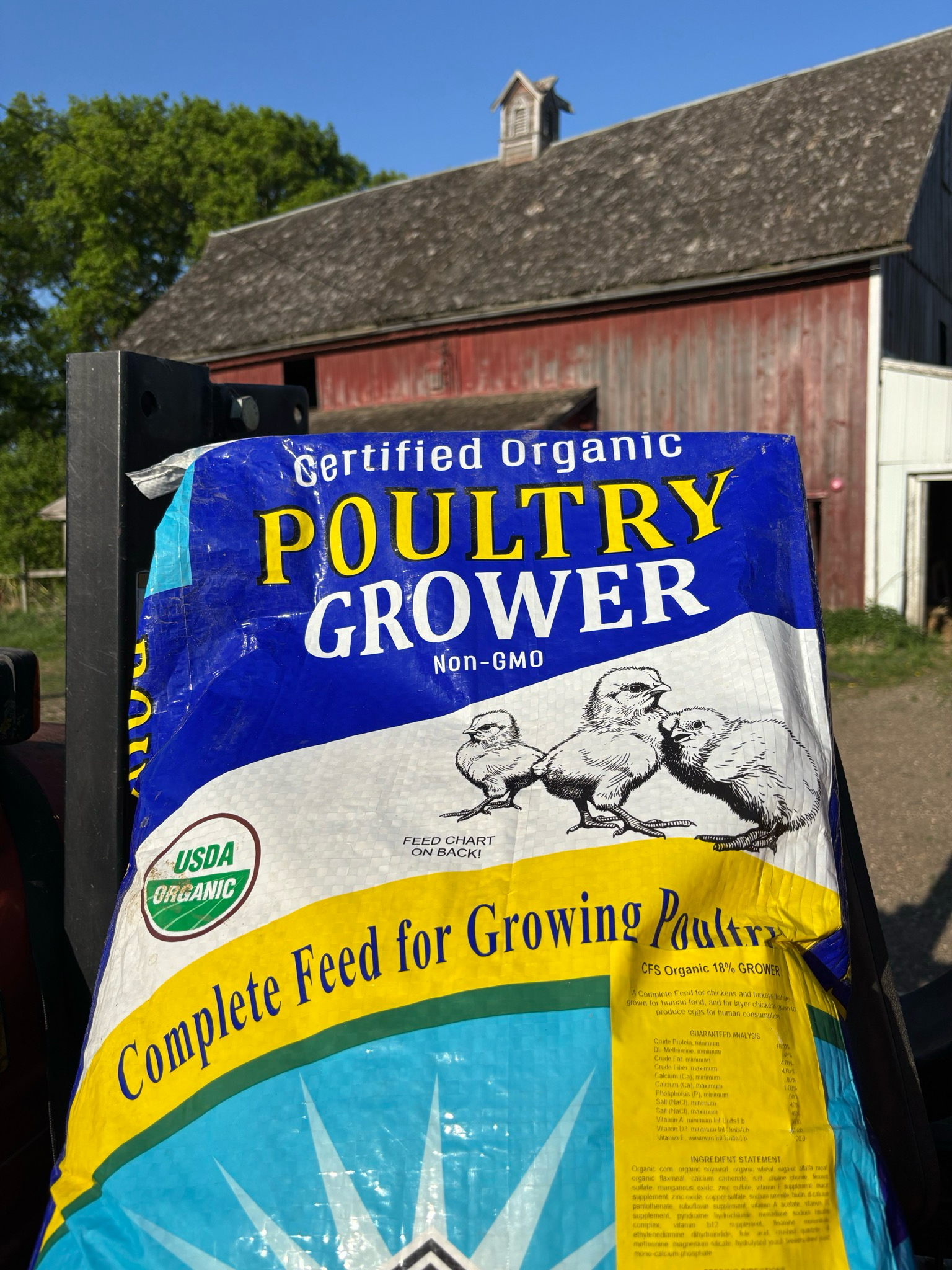 Close-up photo of a 40 lb bag of RCR Organic Poultry Grower Feed, 18% protein, ground texture, certified organic and non-GMO