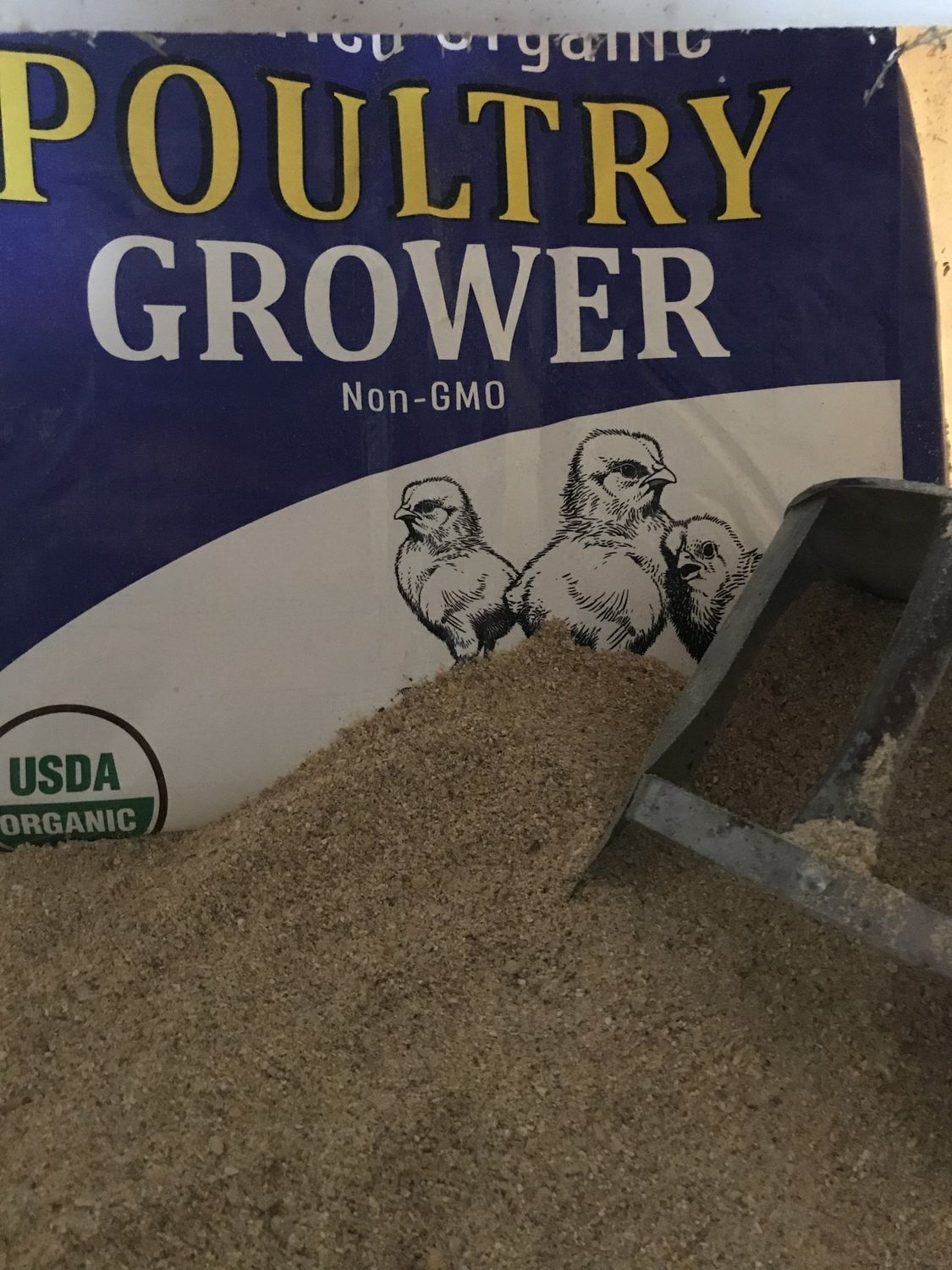 Close-up photo of a 40 lb bag of RCR Organic Poultry Grower Feed, 18% protein, ground texture, certified organic and non-GMO