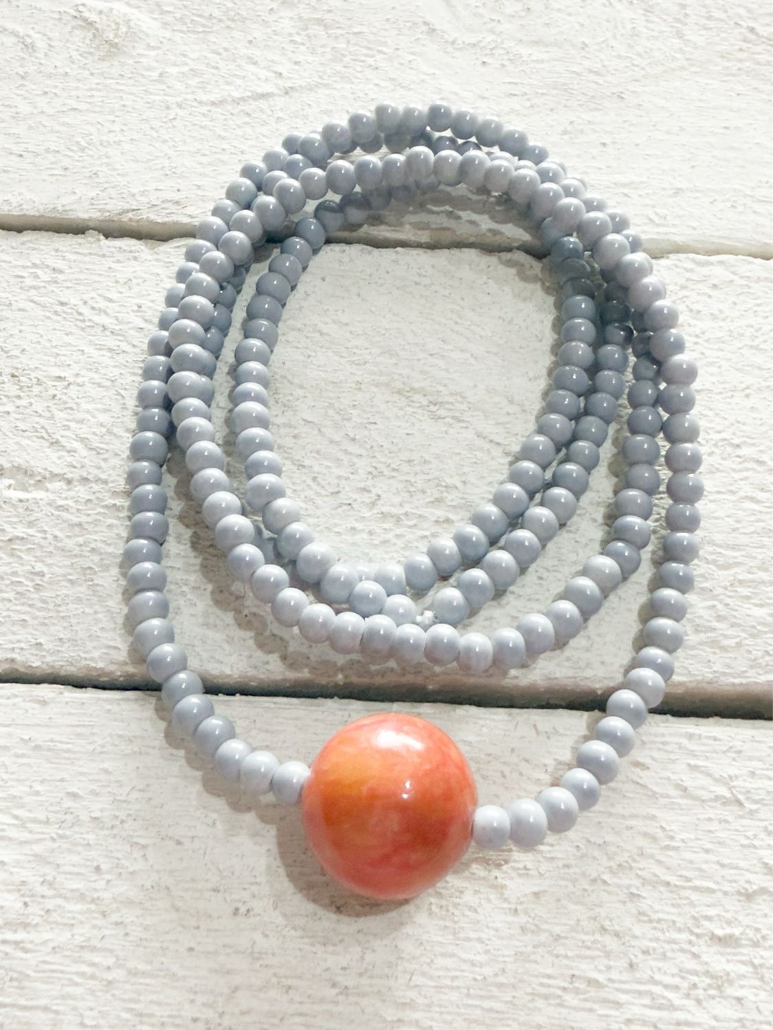 Collar bola gris/teja