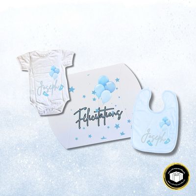 Coffret cadeau naissance bleu avec une boîte cadeau, un body et un bavoir