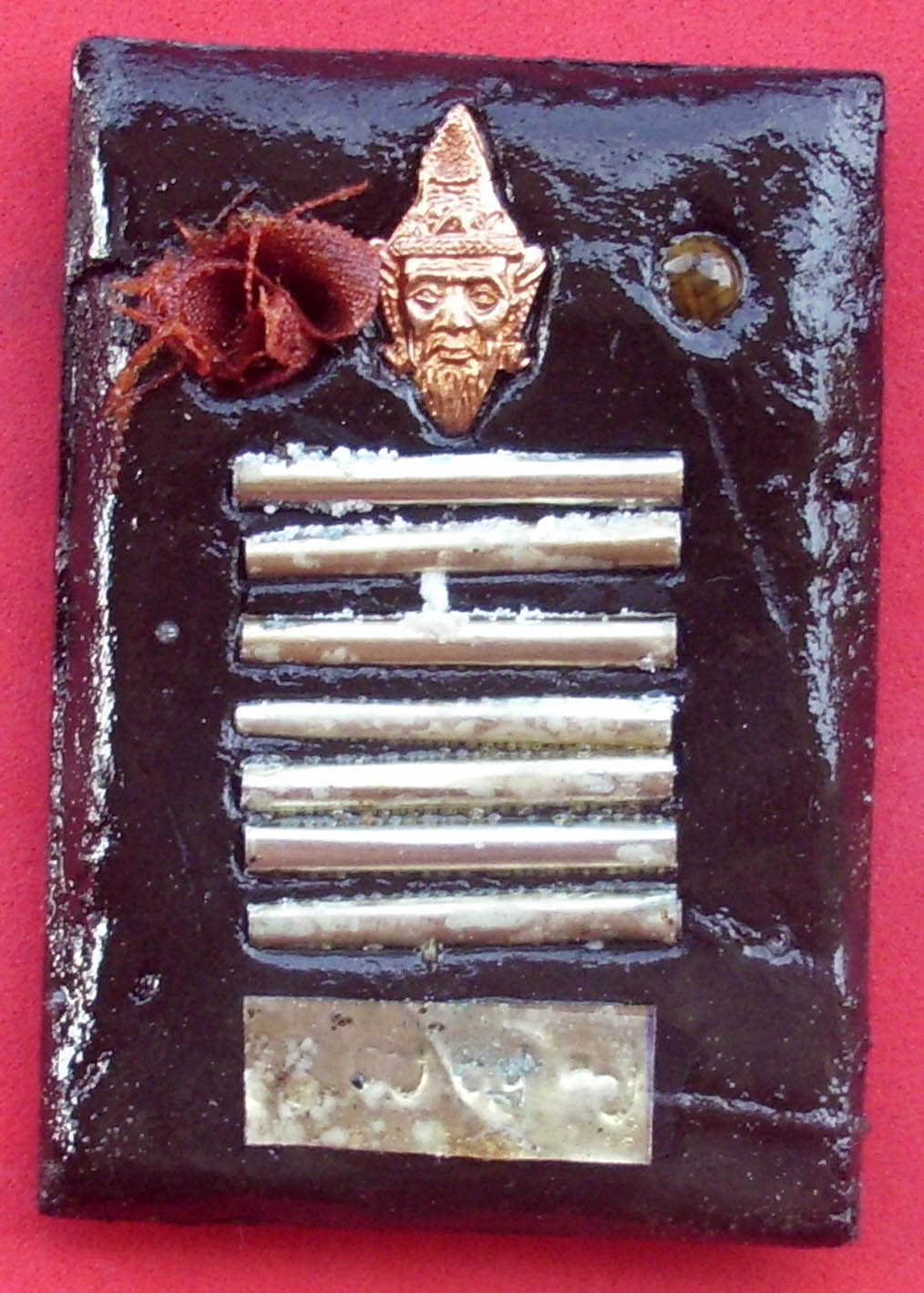 7 Silver Tagrud scrolls, a silver code stamp, sacred powders, pha yant, ploi (semi precious stones empowered with magical properties), and a Ruesi amulet are inserted - no punches pulled as far as the amount of powerful and sacred items included within this amazing amulet