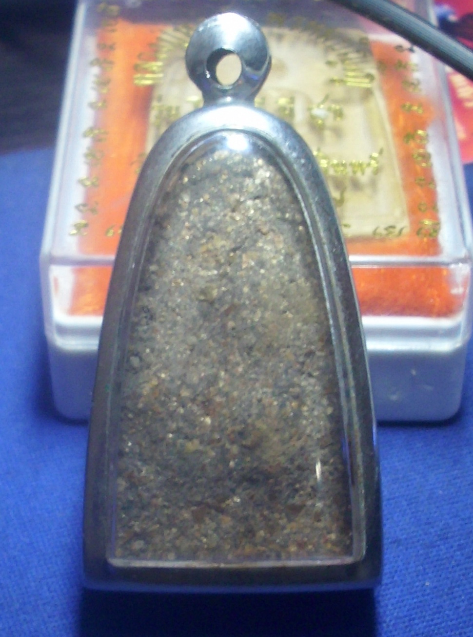 the back face of the Luang Phu Tuad amulet is full of sacred minerals