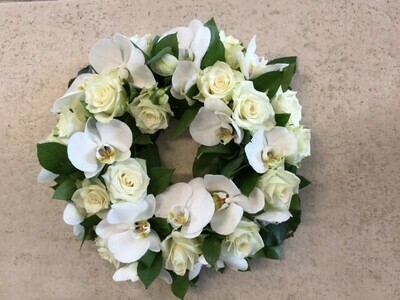 krans met witte rozen en orchideeën