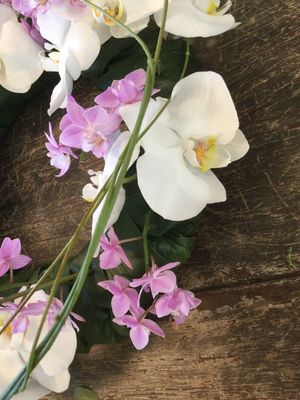 Krans voor rond een urne met witte en roze orchideeen