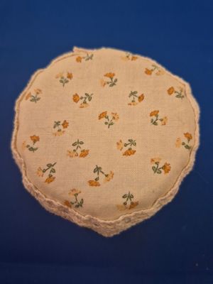 Small orange flowers on cream background beaded drinks cover