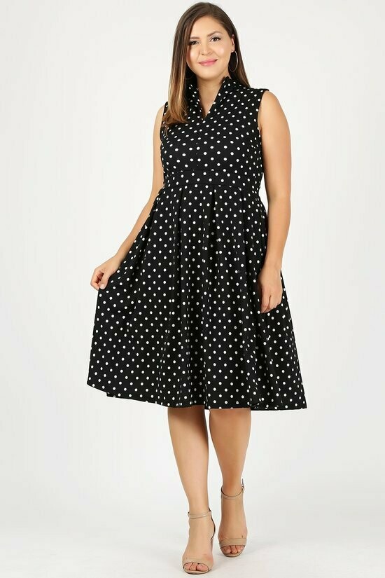 Pleasant Sleeveless polka dot a-line dress with v-neckline, fold over collar, banded waist, and pleated skirt detail.